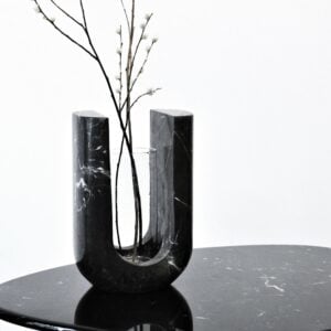 Lago vase hand-carved from a single block of black veined marble in a U shape, holding branches, by Studio Ayres