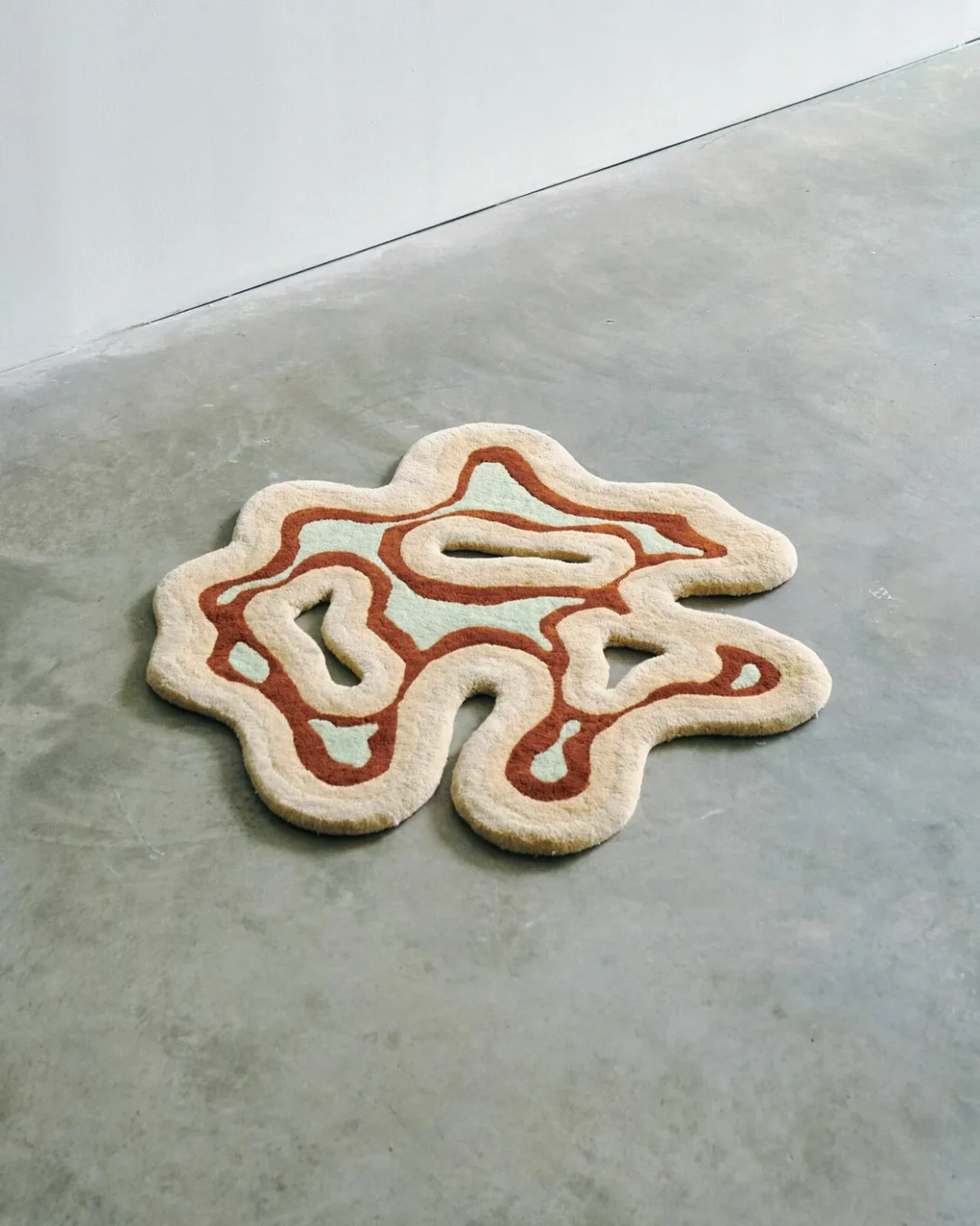The Valley circular cut-out wool rug by Mush Studios