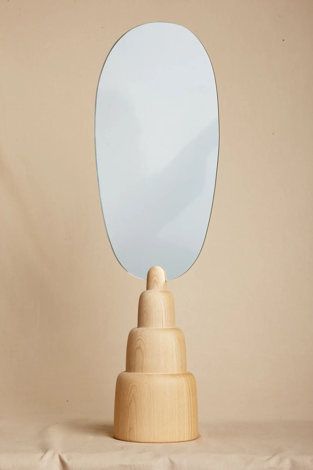Wood and Wax mirror with oval glass on tiered ash base by Ebba Lindgren
