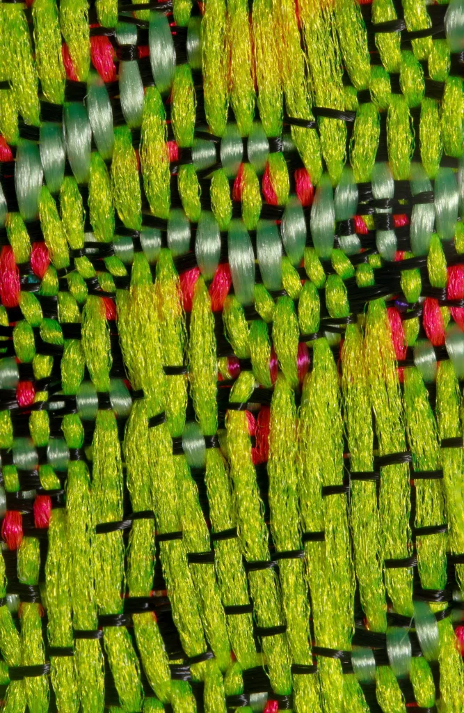 Heat 1 jacquard tapestry by Lucas Gutierrez photographed at an angle to show depth