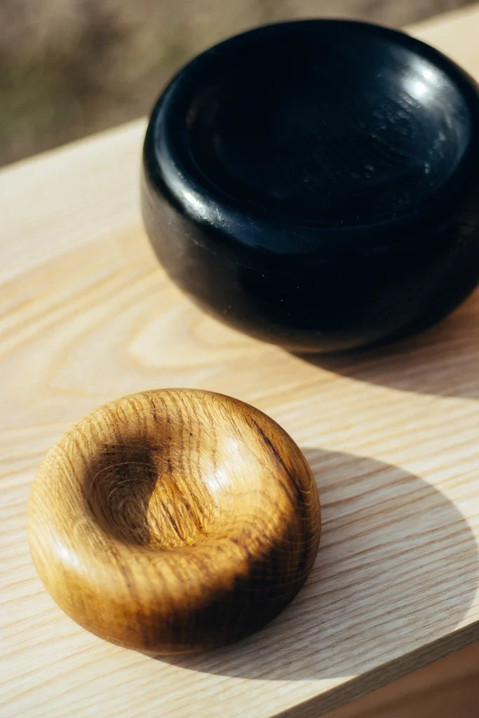Clack bowl turned from ash wood, grain running across the shallow interior