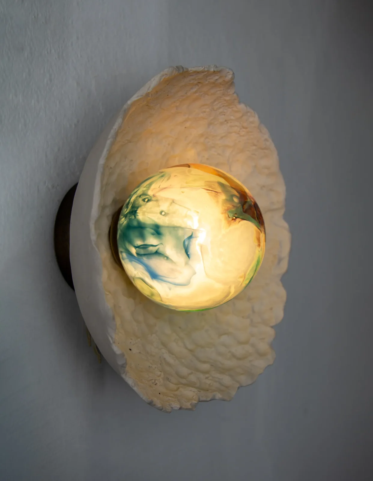 Asea sconce in stoneware and hand-blown glass with wavy sea-inspired texture by Ceren Gurkan