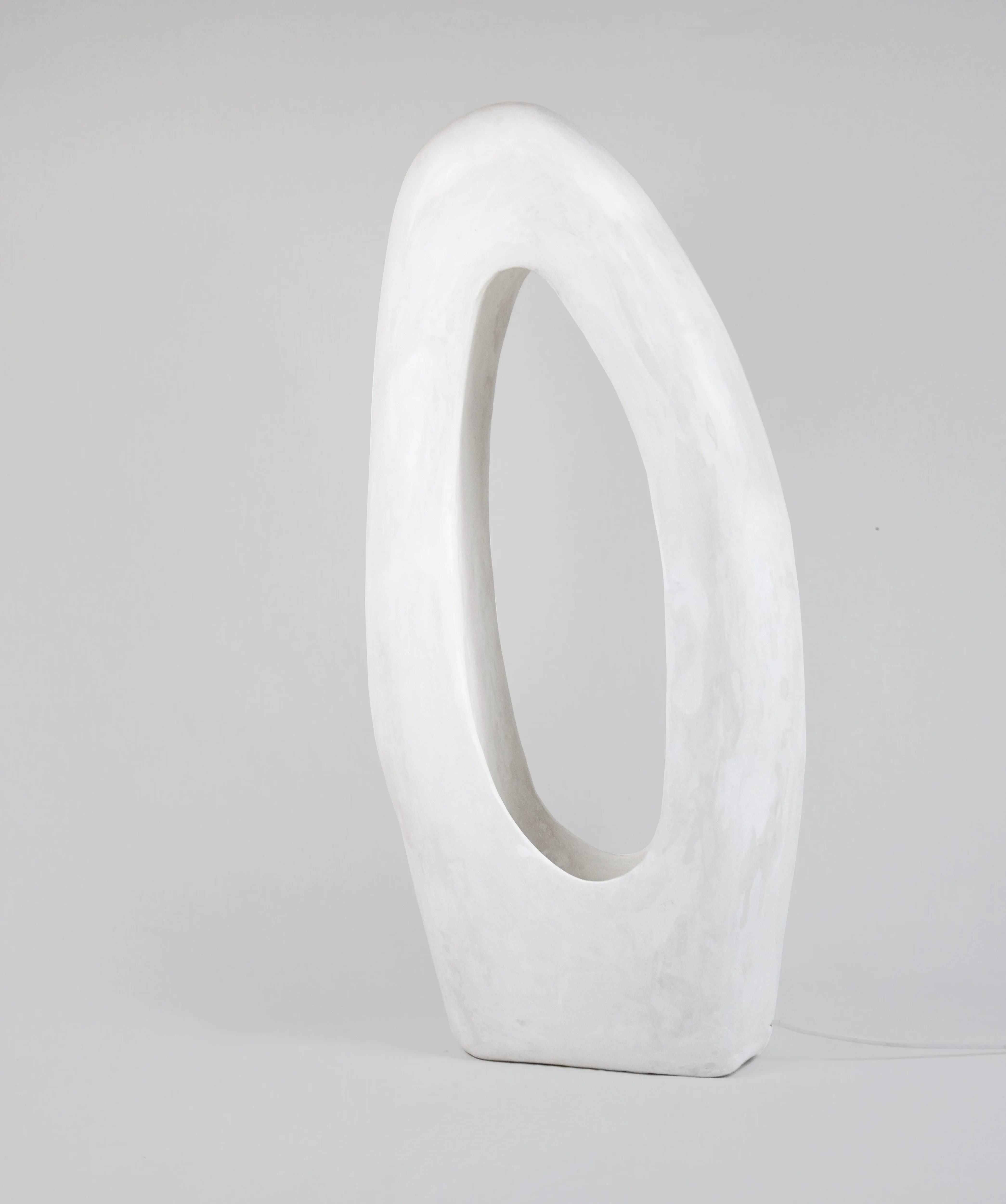 Lacuna hand-carved sculptural floor lamp lit from within by Studio AOAO
