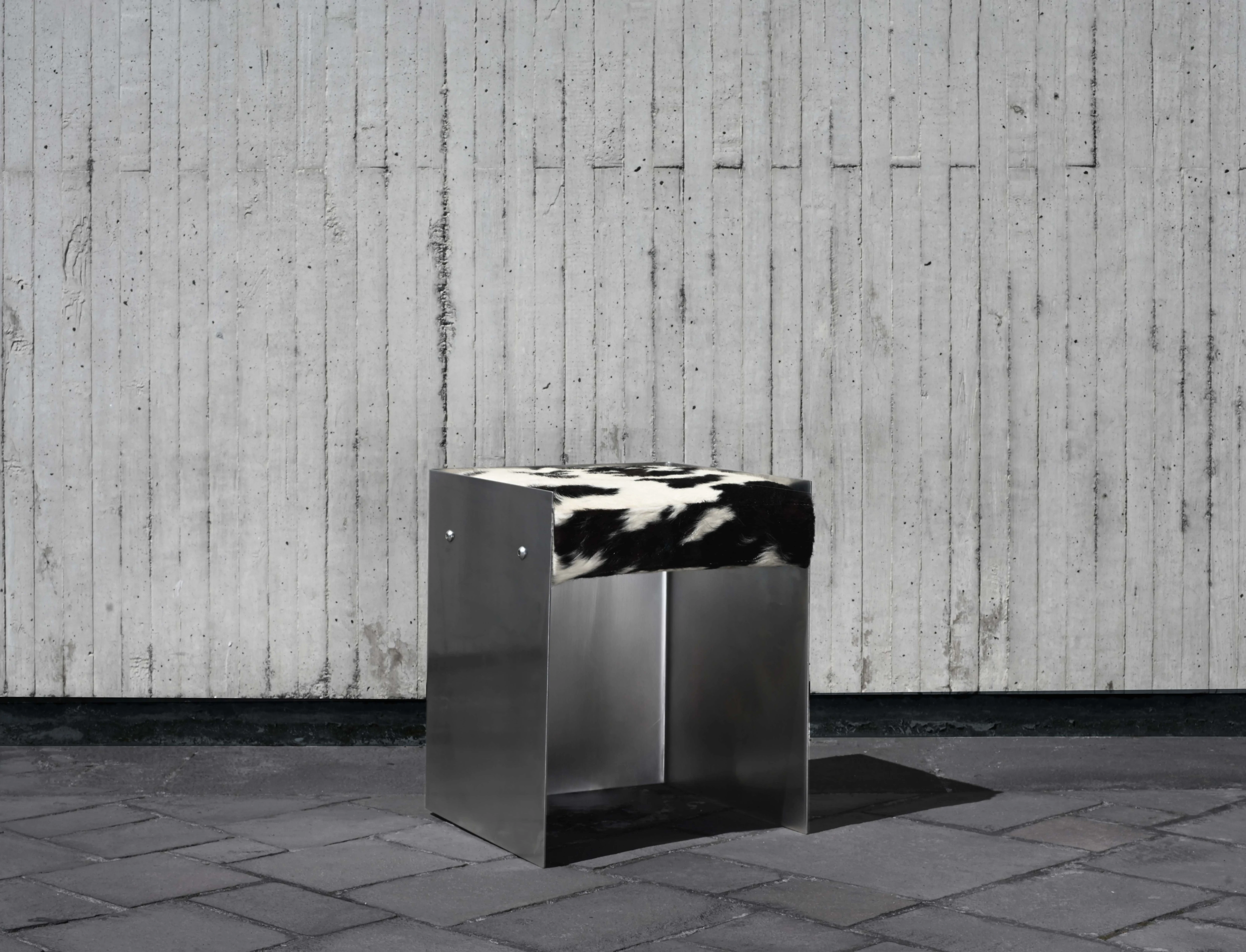 Wrp-003 stool in bent stainless steel with a cowhide seat and exposed bolts by NAVE