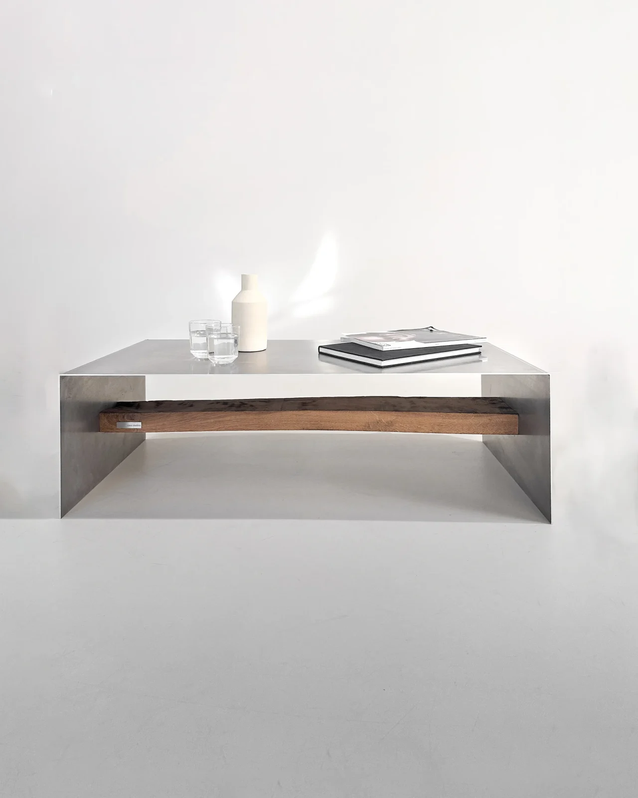 Matted aluminum coffee table by case studios in hand-sanded and waxed aluminium with an oak shelf