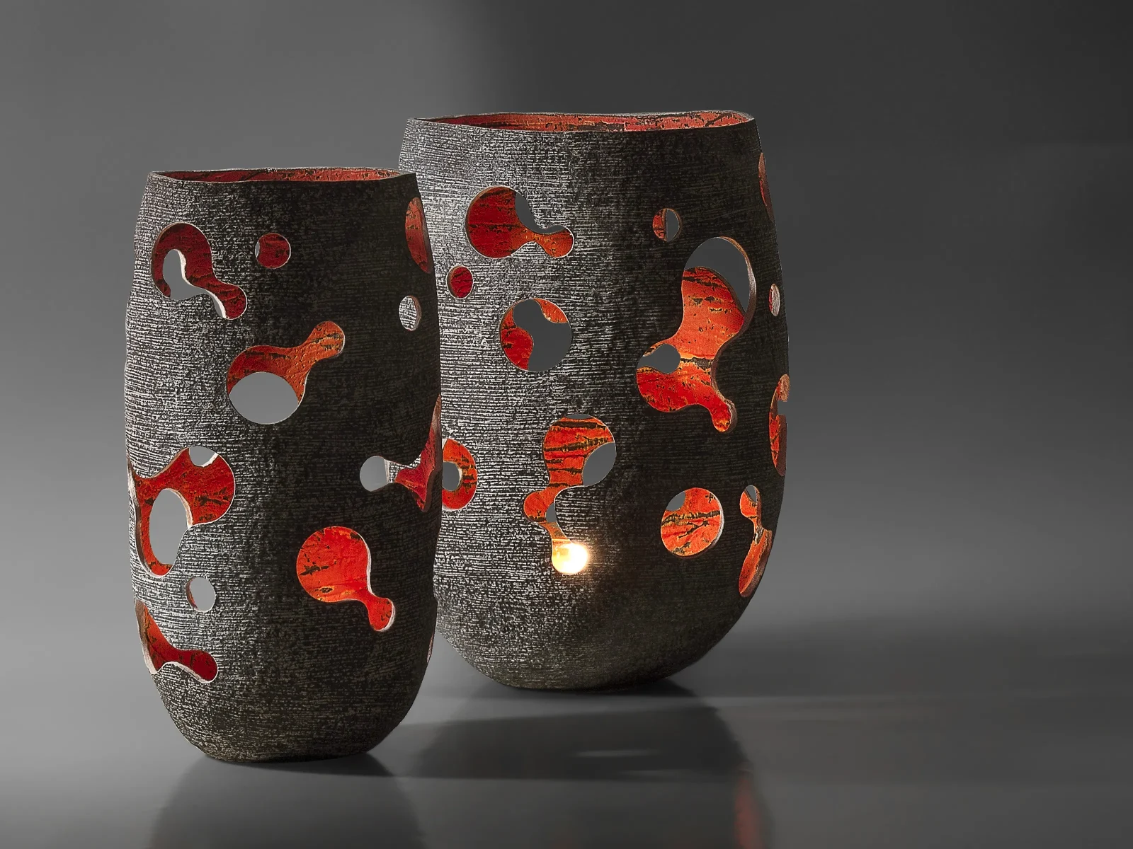 Wide candle lantern carved from solid black stone, with a deep open well