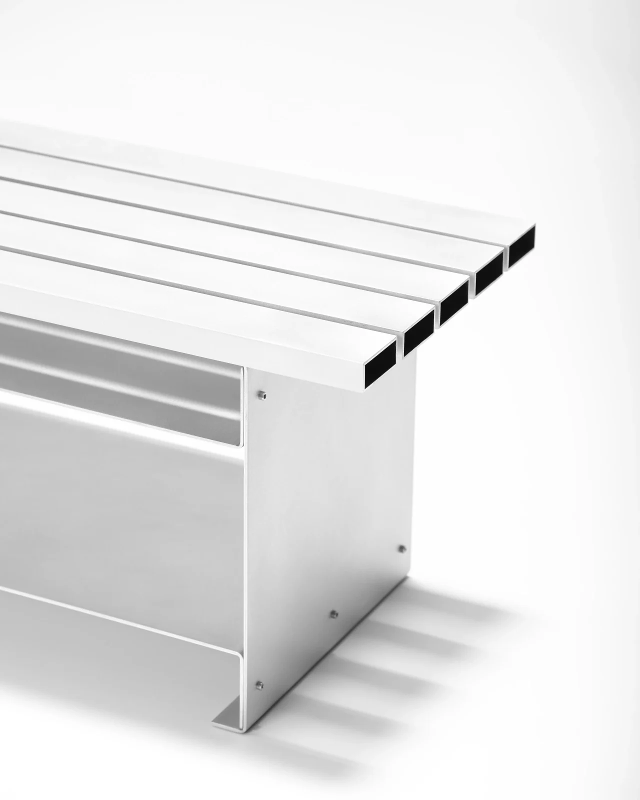 Wing Bench in folded hand-brushed aluminium with storage layer by Obscure Objects