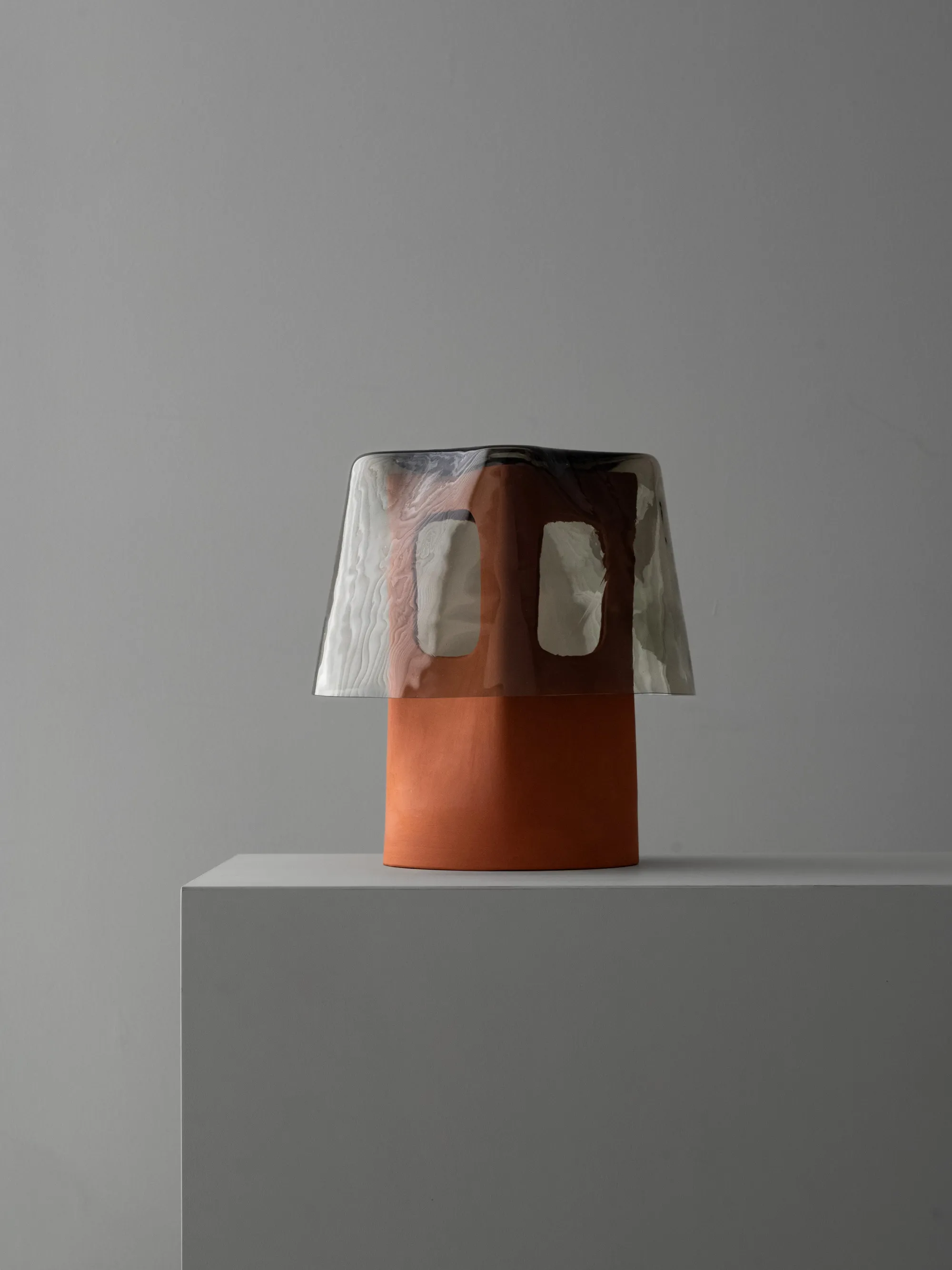 The Mesia white ceramic table lamp with a green glass shade by Luis Gimeno Design