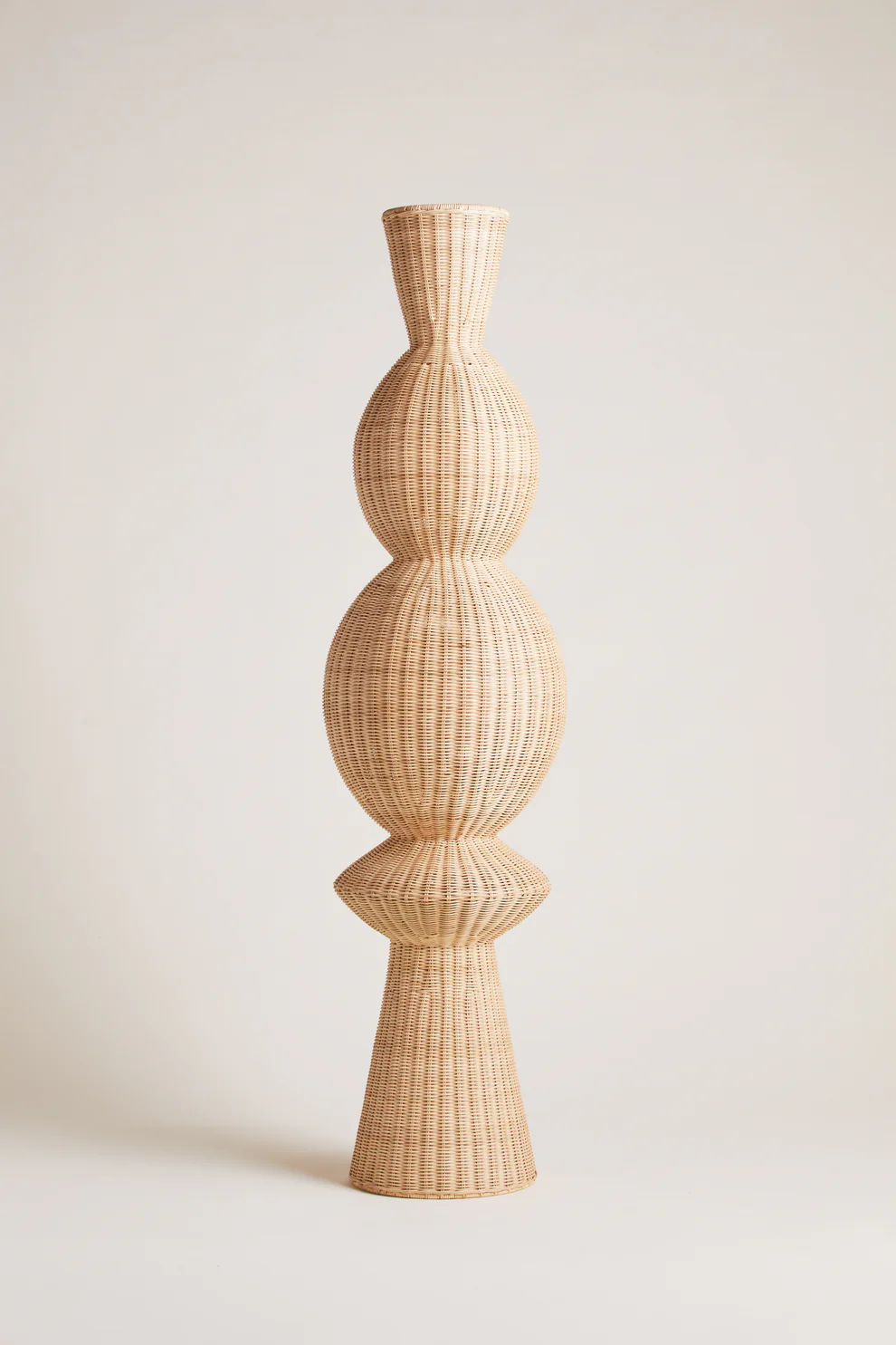Manon floor lamp in a natural rattan-look material by Heaps and Woods