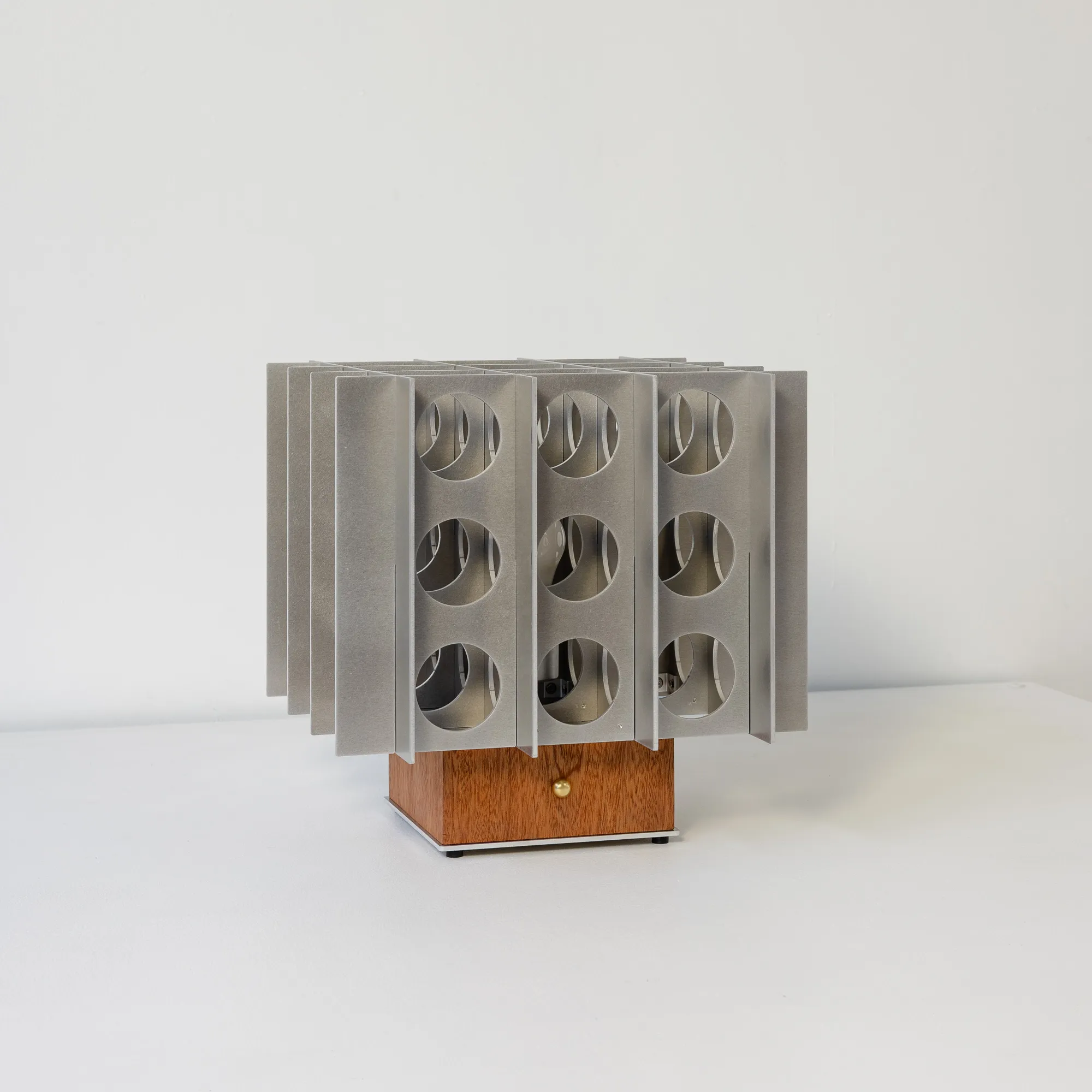Tenfold Low table lamp with perforated aluminum diffuser on a sapele wood base by Luft Tanaka Studio