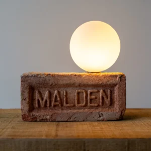 Helen table lamp with reclaimed brick base and frosted glass globe by Solmistudio