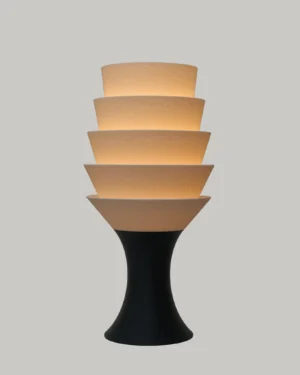 Empilé Petit Table Lamp in Jade White PLA with a black base, on a table.
