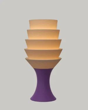Empilé Petit Table Lamp in Jade White PLA with an Iris Purple base, on a table.
