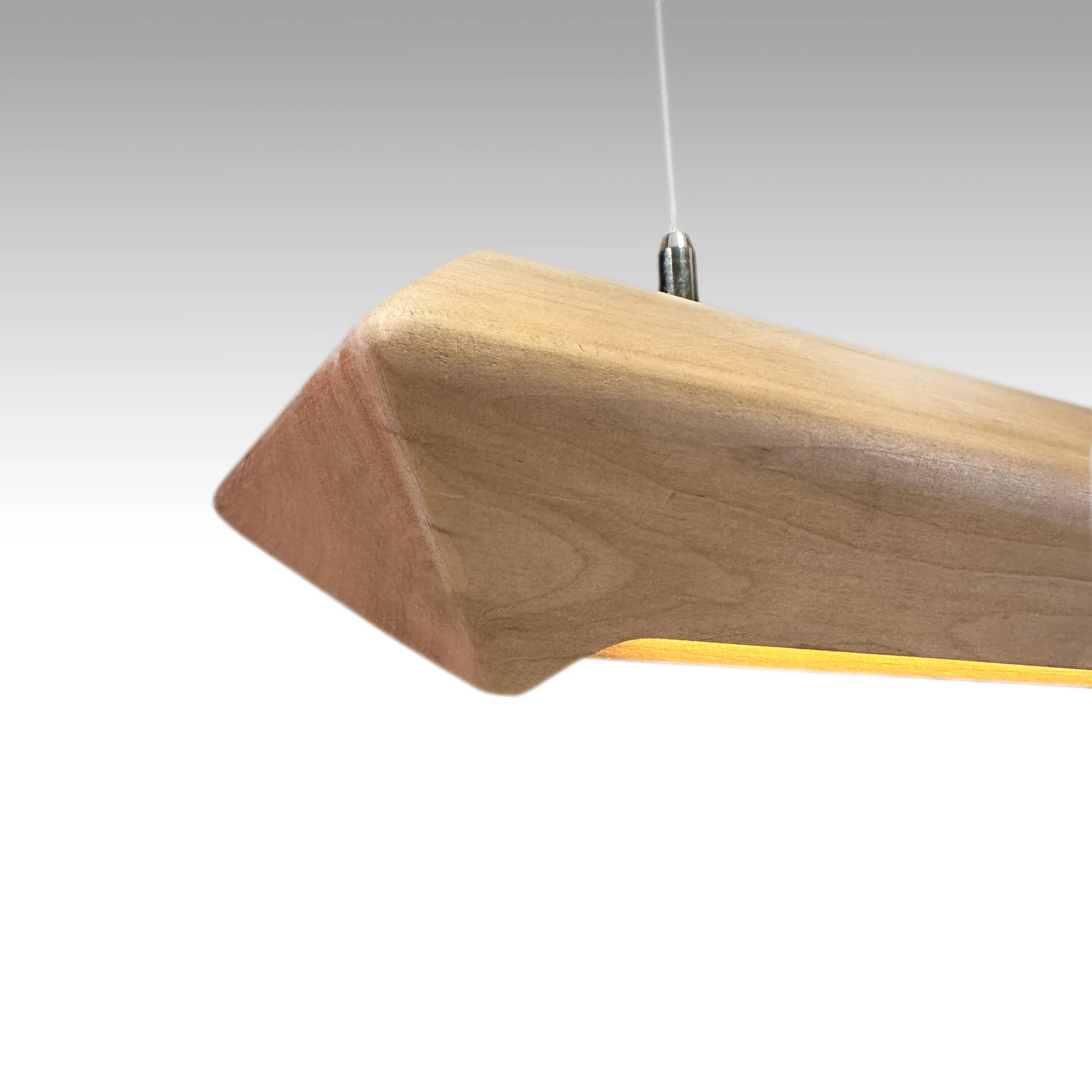 Patagonia elongated pendant lamp carved from a single piece of Patagonian lenga wood by espina corona
