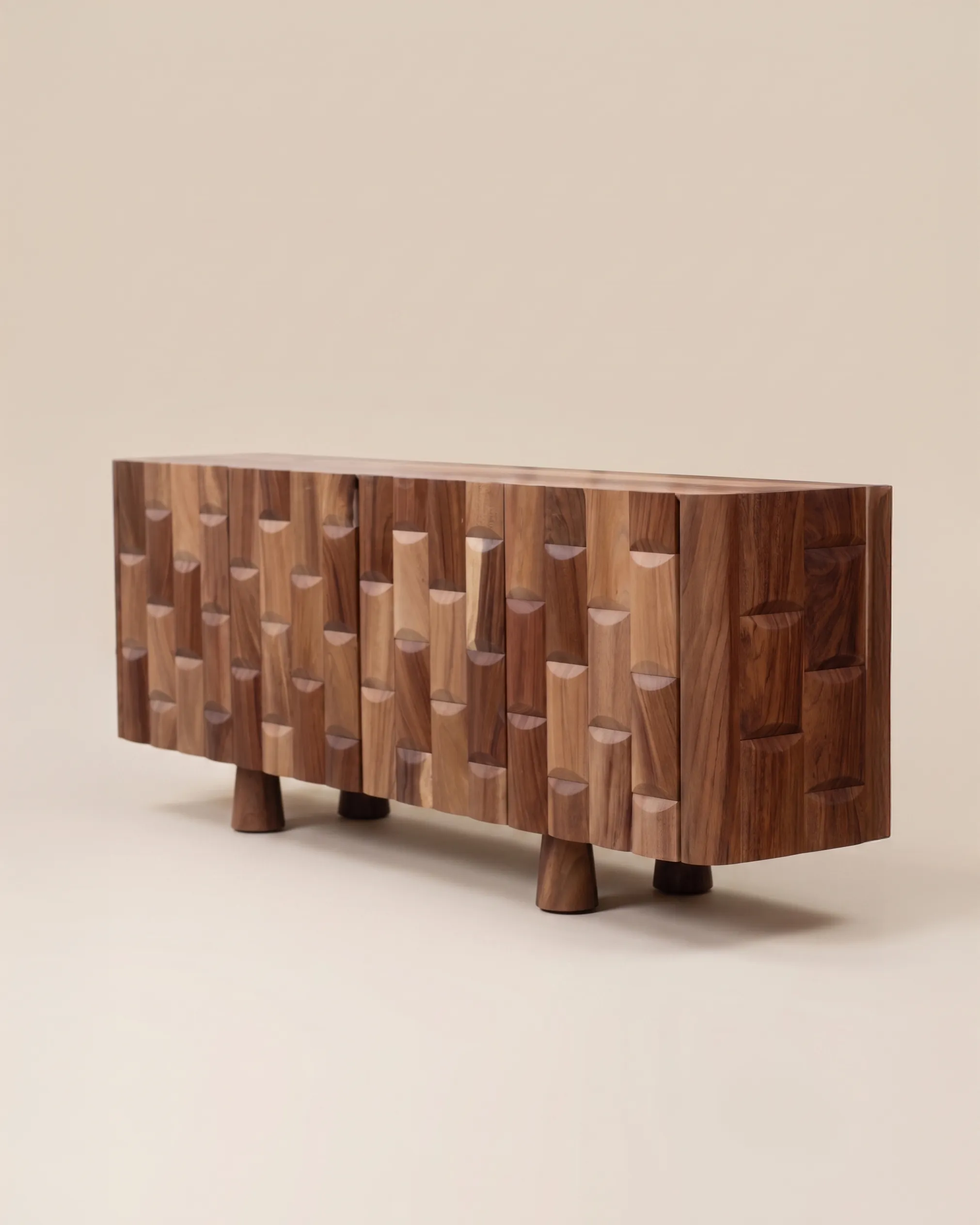 Phloem credenza by CMX Furniture in carved parota wood with a rhythmic geometric facade