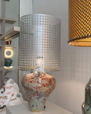 Veil IV Jade Table Lamp in stoneware with a perforated aluminum shade, on a table.