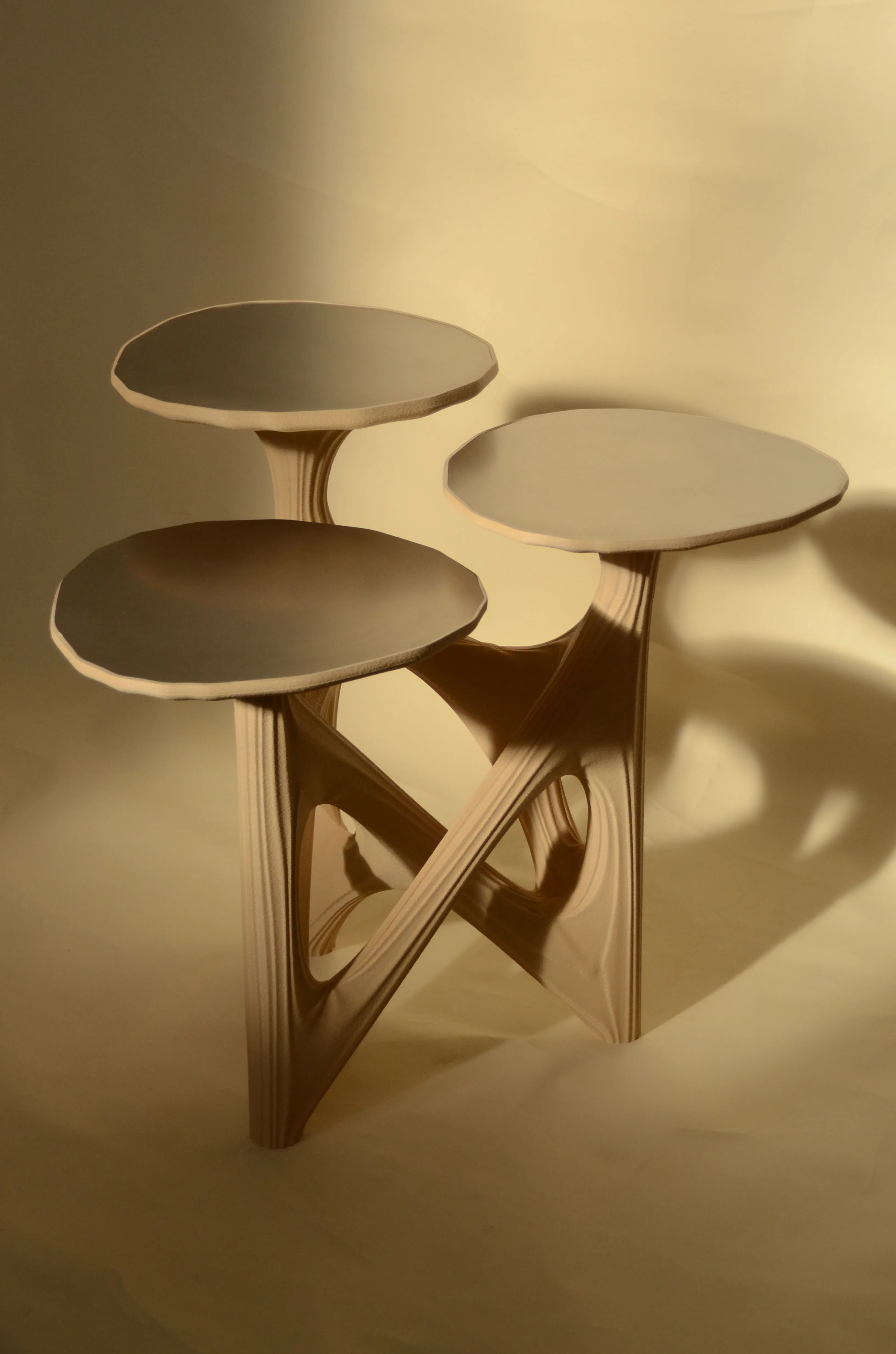 Dendria sculptural side table in sand biopolymer with three brushed stainless steel tops at staggered heights by diploria studio