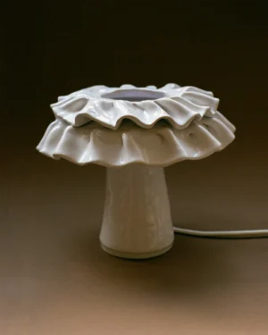 Lulu Table Lamp in hand-painted glazed stoneware on a table, front view.