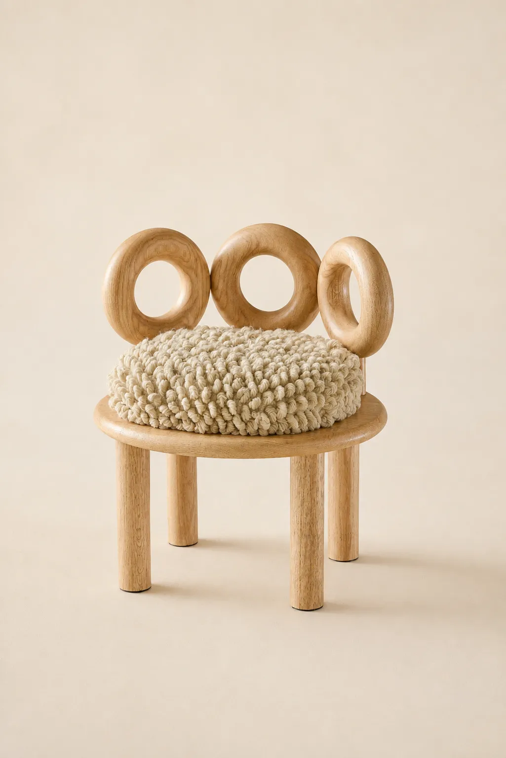 Hooop accent chair in solid wood with a backrest of three wooden rings and a handwoven wool seat by Joyful Objects, Yes!