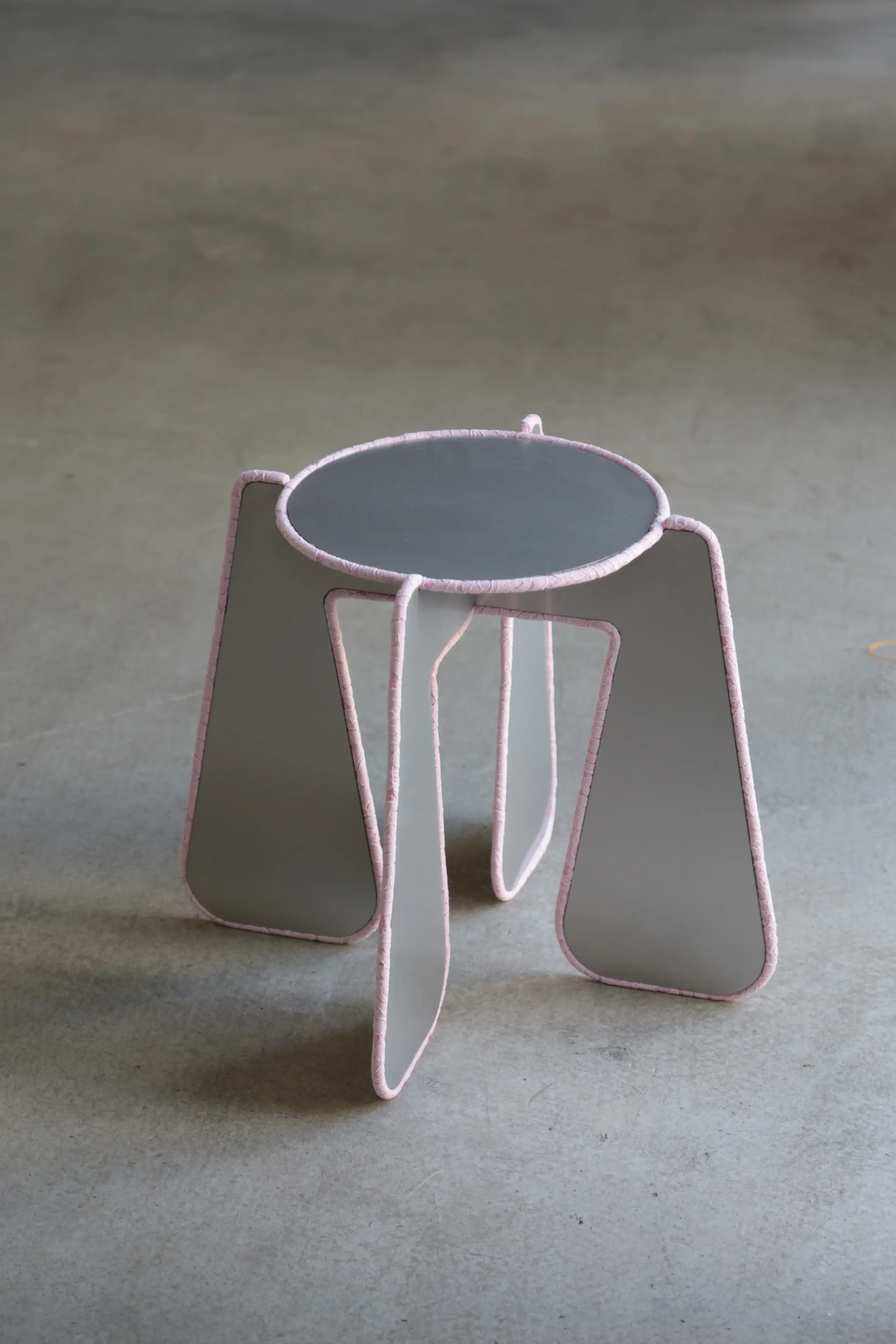 In Between pink side table with hand-finished lace piping between stainless steel planes by please touch studio