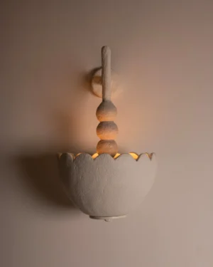 Scallop Wall Sconce in off-white stoneware on a wall, front view.