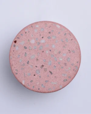 Wilo Blush Wall Sconce in pink terrazzo on a wall, front view.