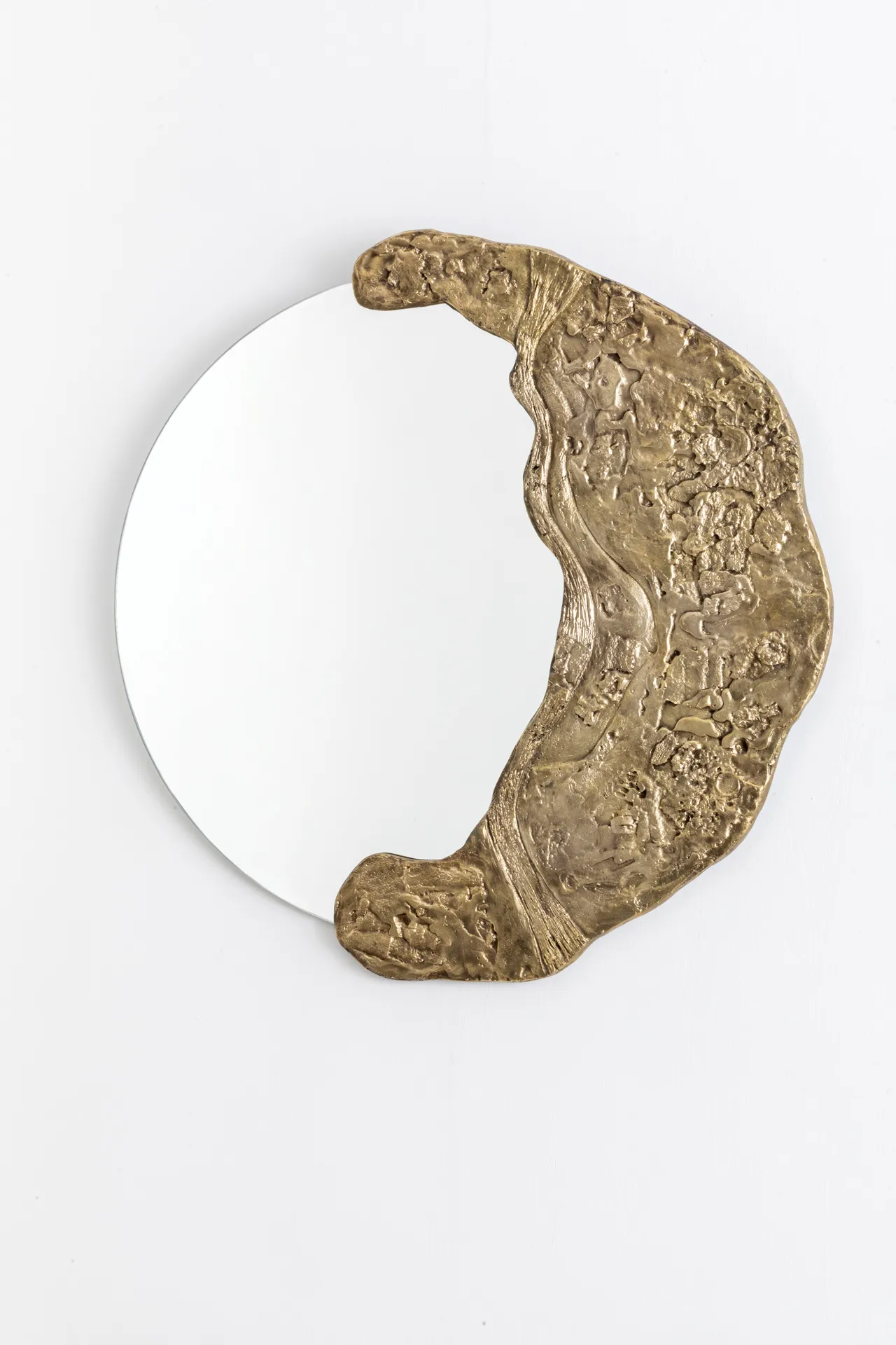 Mooncrater mirror with a cratered frame cast in 80 percent recycled bronze by Wanderart