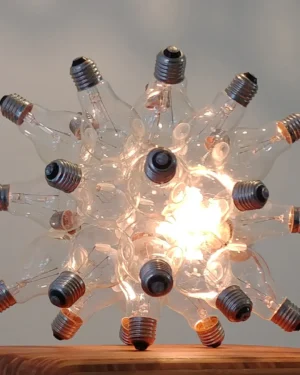 "Spare" Table Lamp in clear glass light bulbs on a wooden table, front view.