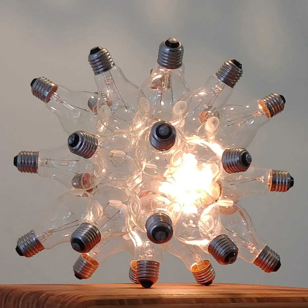 Spare table lamp made from 26 clear glass light bulbs clustered like bubbles by JAN PAUL