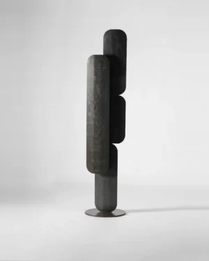Nucleation Floor Lamp in matte blackened steel on a floor, front view.