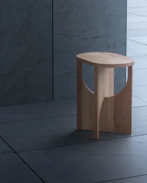 Milano Side Table by Shinichi Utsumi, cedar side table with oval top and arched cutouts, on a slate tiled floor