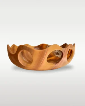 Lava Sun Bowl by Studio Ayres, tiger onyx bowl with scalloped rim and round cutouts, on a plain background