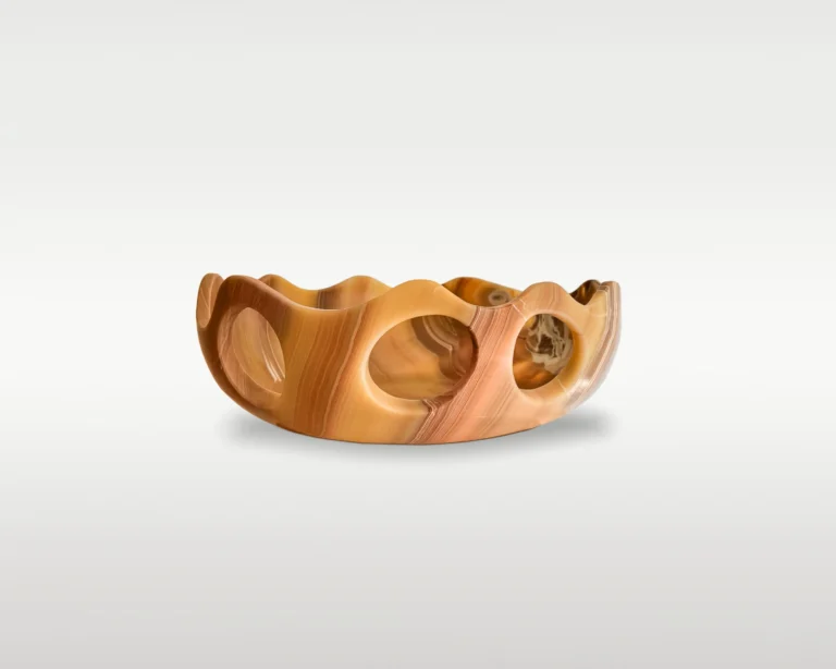 Lava Sun Bowl by Studio Ayres seen from another side, banded amber and pink onyx showing three round cutouts