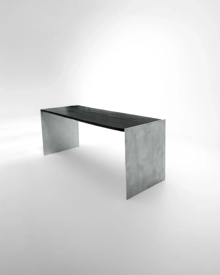 Yakisugi Desk by case studios, charred oak top on two aluminum side panels, on a plain background