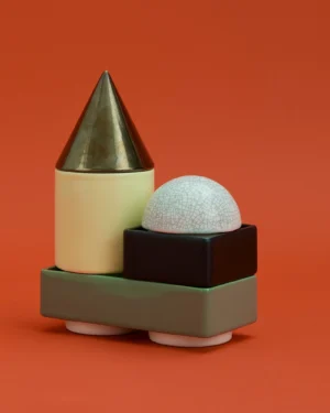 Knstrkt Set Of 5 by Studio Berg, stacked cone, cylinder, dome and block pieces in glazed stoneware, on an orange background