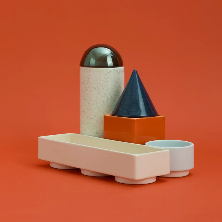 Knstrkt Set Of 6 by Studio Berg seen from a raised angle, showing the open tray, orange square box and blue cone