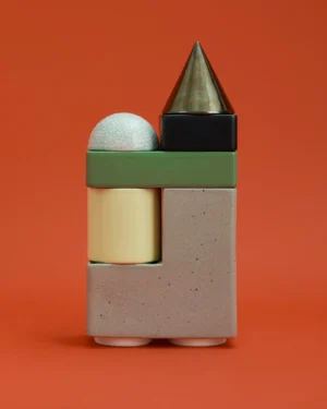 Knstrkt Set Of 6 With Large Pieces by Studio Berg, stacked green, greige, yellow and black blocks on an orange background