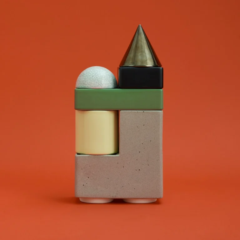 Knstrkt Set Of 6 With Large Pieces by Studio Berg, stacked green, greige, yellow and black blocks on an orange background