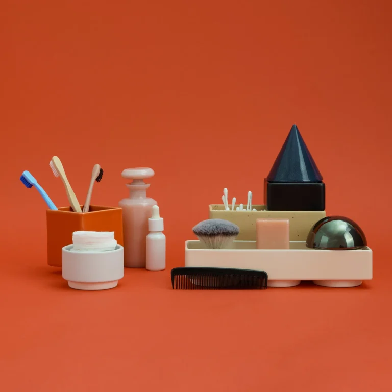 Knstrkt Set Of 7 by STUDIO BERG as bathroom organizers, holding cotton swabs, a brush and soap beside toothbrushes
