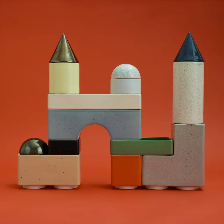 Knstrkt Set Of 14 by Studio Berg seen from the front, blocks stacked into a castle with an arch and two cone towers