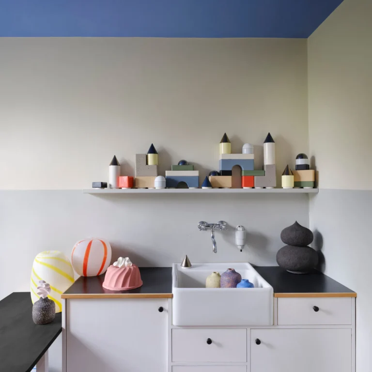 Knstrkt Set Of 14 by Studio Berg in a kitchen, a row of block towers along a shelf above a sink