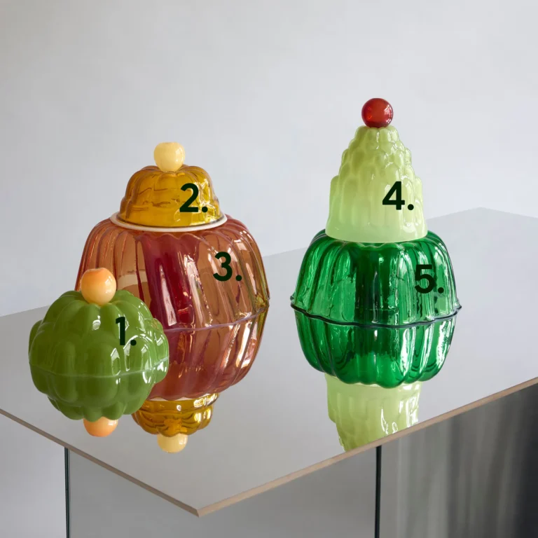 Jello High by Studio Berg, numbered glass cloches in green, amber and pink stacked on a mirrored table