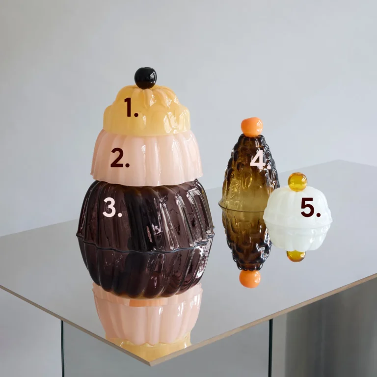 Jello High by Studio Berg, numbered cloches in yellow, pink, brown, amber and white glass on a mirrored table