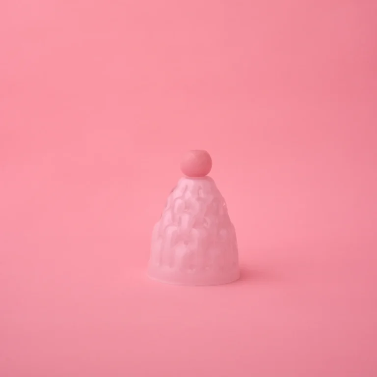 Jello High by Studio Berg, frosted white-pink glass cloche with a pink round knob, on a plain pink background