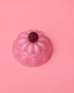 Jello M Hand-blown Glass Cloche by Studio Berg, pink glass with a dark red knob, seen from above on a pink background