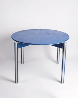 Sigma 01 Dining Table in Aluminum and Birch Plywood by 301 Design Studio, round blue top on aluminum legs, plain background