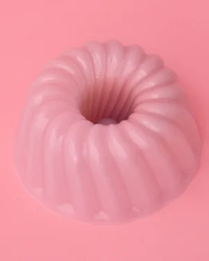 Jello Xl Hand-blown Glass Cloche by STUDIO BERG seen from above, pale pink fluted glass ring on a pink background