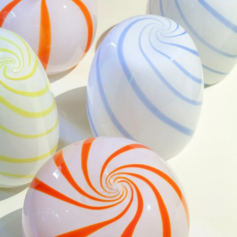 Close-up of the Blue Candy Side Table's blue swirl stripes, grouped with orange and yellow striped glass pieces