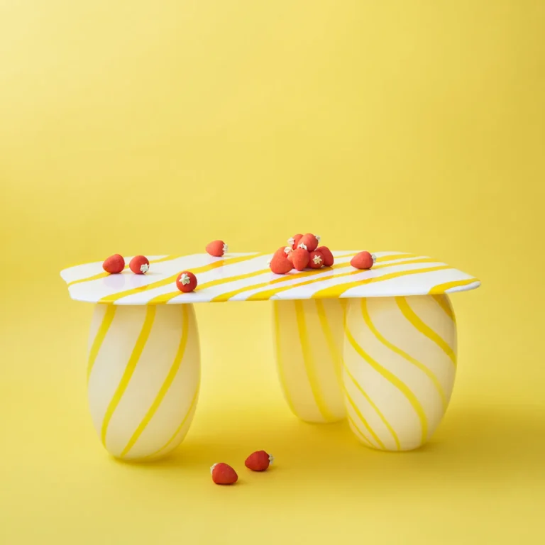 Yellow Candy Sofa Table by Studio Berg, white and yellow striped glass top scattered with small red strawberry sweets