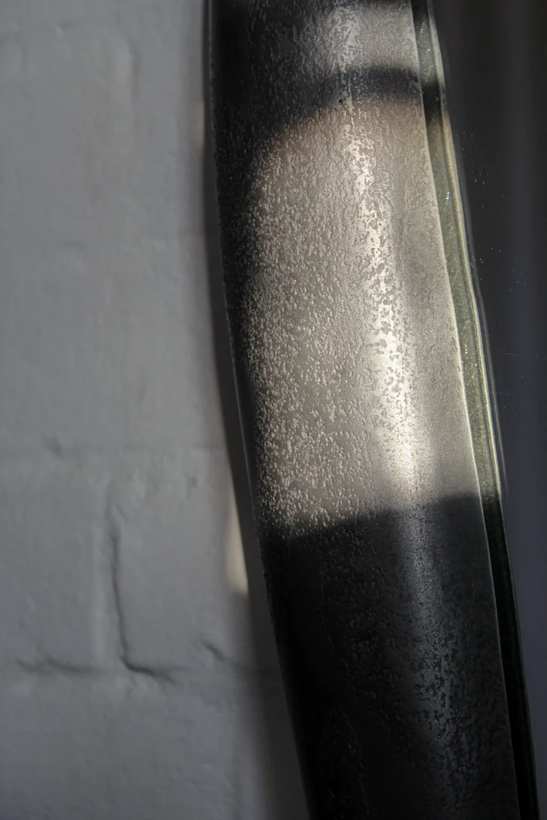 Close-up of the Mirror Perfumer's frame by Vogel Studio, its textured cast surface catching light and shadow